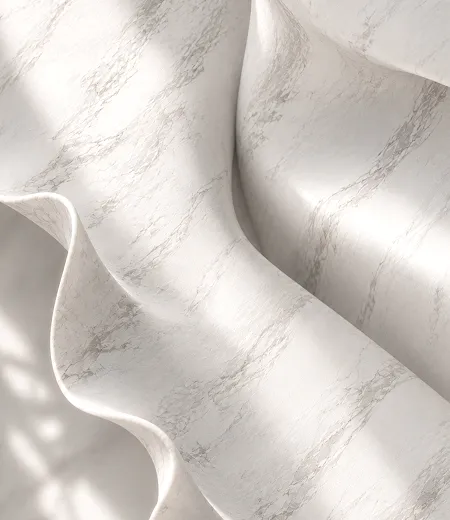 A soft fold of white marble-look surface in the light