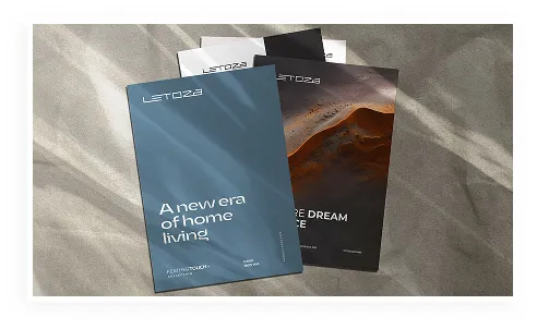 Tile catalogues and brochures laid out on a dark surface